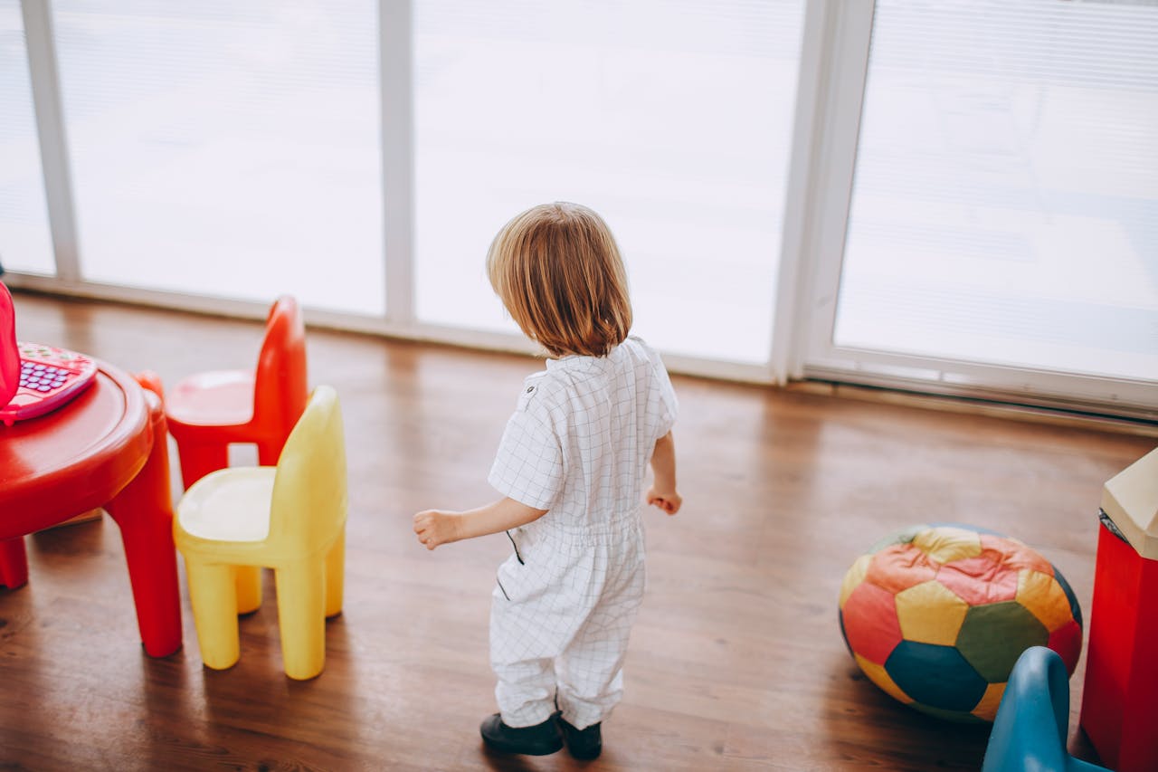 The Art of Drawing Readers In: Your attractive post title goes here Young child in a colorful playroom with toys and child-sized furniture.