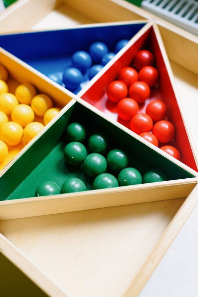 Close-up of colorful balls arranged in a triangular wooden toy, ideal for educational games.